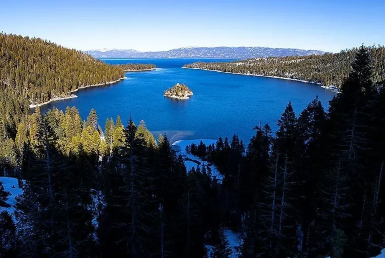Emerald Bay and Fannette Island framed by pine forest and winter snow at Lake Tahoe